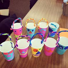 many colorful cups are sitting on a table