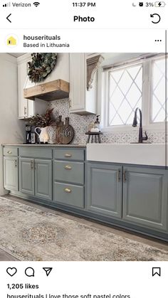 an image of a kitchen with blue cabinets and white counter tops on the left side