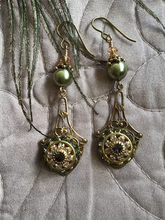 Swarovski green pearls, and olivine and crystal elements, ornate bead caps topped with topaz crystals. Ear friendly niobium shepherd hooks. Green Dangle Jewelry With Bead Caps, Dragon Rider, Green Pearls, Bead Caps, Jewelry Earrings Dangle, Topaz, Etsy Earrings, Dangle Drop Earrings, Dangle Earrings