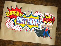 a piece of paper with the words happy birthday written on it and an image of a woman wearing a cape