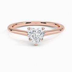 a rose gold engagement ring with a heart shaped diamond