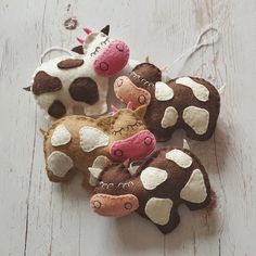 several stuffed animals are sitting together on the floor next to each other, one is brown and white