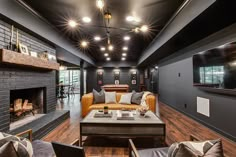 a living room filled with furniture and a fire place in front of a tv mounted on the wall