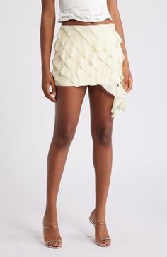 Frothy side ruffles add a sweet, sophisticated flourish to a fluttery tiered miniskirt made from crinkled georgette in a off-white shade. Back zip closure Lined 100% polyester Dry clean Imported Elegant Ruffled Mini Skirt For Spring, Elegant Spring Mini Skirt With Ruffles, Chic Ruffled Mini Skirt For Party, Chic Party Mini Skirt With Ruffles, Chic Tiered Pleated Bottoms, Chic Pleated Tiered Bottoms, Chic Mini Skirt With Layered Hem, Tiered Ruffle Mini Skirt For Party, Chic Ruffled Mini Skirt For Spring