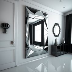 a mirror on the wall in front of a black and white cabinet with two mirrors