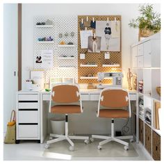 two office chairs sitting in front of a desk