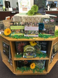 the bookshelf is filled with many books and flowers on display for everyone to read