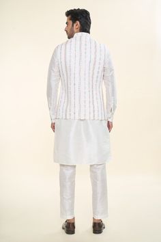 Off white solid kurta. Paired with a Nehru Jacket with thread embroidery and a matching plain mexican pant. - Aza Fashions White Sherwani With Chikankari Embroidery For Spring, Spring White Sherwani With Chikankari Embroidery, White Nehru Jacket With Stand Collar For Festive Occasions, Festive White Outerwear With Chikankari Embroidery, White Traditional Bandhgala For Spring, Fitted White Sherwani For Spring, White Fitted Sherwani For Spring, White Long Sleeve Bandhgala For Spring, White Festive Nehru Jacket With Stand Collar