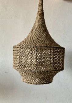 a woven light fixture hanging from the ceiling