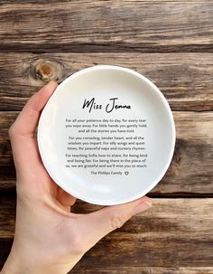 a person holding a white plate with a poem on it