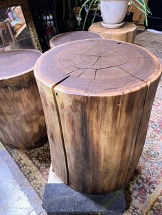 two wooden stools sitting next to each other on top of a carpeted floor