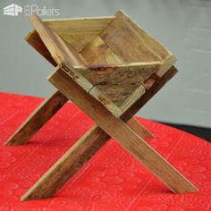 a wooden chair sitting on top of a red table