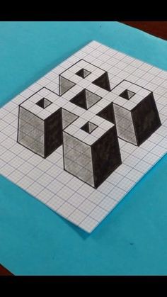 a piece of paper that has been cut into squares and cubes on top of it