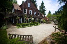 a large house surrounded by lush green trees