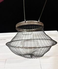 a wire basket hanging from the ceiling