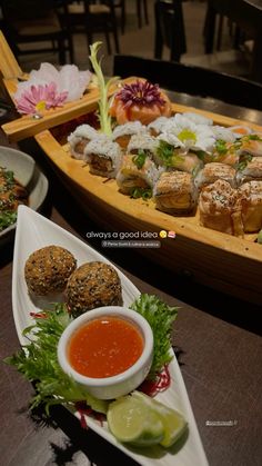 sushi platter with dipping sauces and vegetables on the side at a restaurant