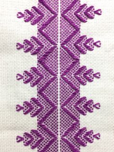 a close up of a piece of cloth with purple thread