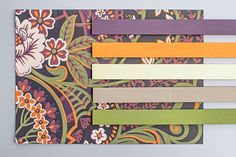 several strips of colored paper are arranged on top of each other with flowers and leaves