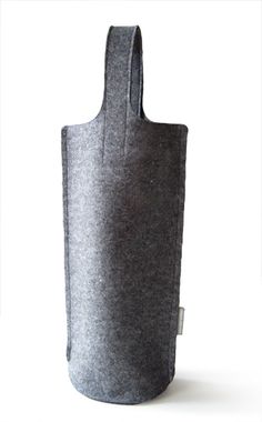 a gray felt bag sitting on top of a white surface