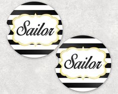 two black and white striped coasters with the word sailor in gold lettering on them