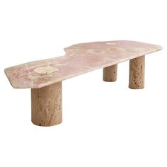 a pink marble bench sitting on top of a white floor next to a wooden pole