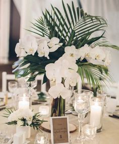 white flowers and candles are on the table