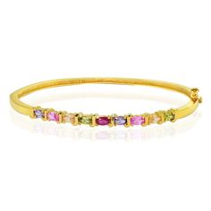 This bangle features prong set multi-colored various stones intermediated by S designs. It showcases 2 created pink sapphire stones, 2 simulated amethyst stones, 2 green CZs, 2 champagne CZs, and one red amber CZ stone. The bracelet is crafted of gold over sterling silver. Wear this chic bracelet solo, or pair it with other bangles for a dramatic effect. Color: Metal Type. Gender: female. Age Group: adult. Multicolor Gemstone Accented Bangle Bracelet, Multicolor Gold Bracelet With Gemstones, Gold Multi-stone Bangle Jewelry, Multicolor Multi-stone Bangle, Vintage Multi-stone Bangle Bracelet, Elegant Multicolor Multi-stone Cuff Bracelet, Chic Bracelet, Sapphire Stone, Amethyst Stone