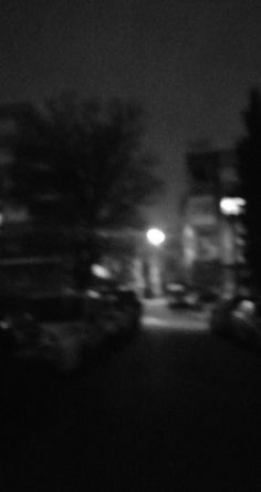 blurry image of cars parked on the street at night