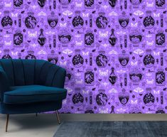 a blue chair sitting in front of a purple wall with black and white designs on it