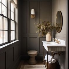 a white sink sitting under a bathroom mirror next to a window