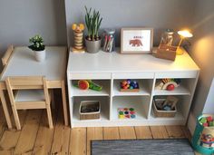 a toy room with toys and books on the shelves