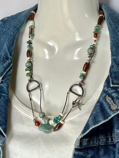 Fun Freeform necklace of Turquoise, Bone, Carnelian, Silver Alloy and Turquoise  Czech Millieflori beads, on two strands of 1mm leather cord. A Silver Starfish charm that can be deleted or changed but adds a bit more whimsy.  Main turquoise  stone is 1' and total length of necklace is 22" with toggle clasp to close No lead or nickel used. Please use the Last On, First Off approach. Stones discolor with lotions, perfumes, hairspray, sweat, chlorine, even some soaps, and will break if dropped. Adjustable Bohemian Turquoise Necklace With Lobster Clasp, Adjustable Bohemian Turquoise Necklace, Southwestern Brown Turquoise Necklace With Natural Stones, Southwestern Boho, Trendy Boho, Genuine Turquoise, Czech Beads, Toggle Clasp, Boho Hippie