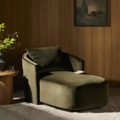 a green chair sitting in front of a wooden wall