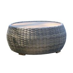 a round wicker coffee table with wooden legs and a wood top on an isolated white background