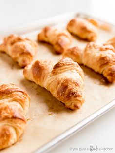 freshly baked croissants on a baking sheet