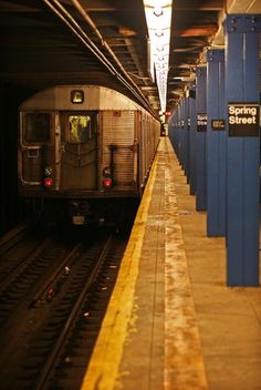 a subway train pulling into the station at night