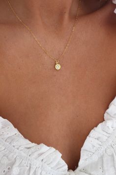 Gold Sun Necklace | Gold Necklace | Sunshine Necklace | Minimalist Necklace | Dainty Necklace | Delicate Necklace | Simple Gold Necklace DETAILS: * PENDANT is Gold Plated with a Cubic Zirconia, measuring 9mm * CHAIN is 14k Gold Filled * CLASP is 14k Gold Filled Model is wearing a 16 inch chain GOLD PLATED CARE: * Always remove jewelry before swimming, bathing, doing household chores, or using abrasive cleaners. * Apply beauty products such as perfume, hairspray or deodorant before wearing jewelr Gold Necklace Delicate, Gold Sun Necklace, Small Gold Necklace, Simple Gold Necklace, Sunshine Necklace, Dainty Gold Jewelry, Delicate Gold Necklace, Pretty Jewelry Necklaces, Sun Necklace