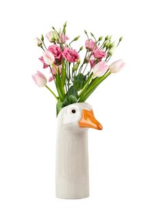 a white vase with pink flowers and a duck's head on the bottom is filled with tulips