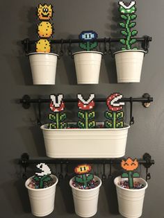 there are some plants that have been made out of legos in the potted planters