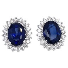 Gorgeous pair of vintage Sapphire diamond cluster earrings handcrafted in solid 18k white Gold. They are set with Bright Natural Sapphire in the center, total weight 2.41 carat, and surrounded by an halo of colorless sparkling Round Brilliant cut Diamonds, graded F/G Color IF. Origin Italy 1980 CONDITION: Pre-owned - Excellent METAL: 18k Gold STONE: Sapphire 2.41 ct. - Diamond 0,40 total carats WEIGHT: 2,6 grams * every jewel is professionally tested by our internal gemological team of specialist I.G.I./HRD **the jewel comes with gemological appraisal and warranty in a nice earrings case Sapphire Earrings Studs Vintage, Luxury Blue Cluster Earrings Fine Jewelry, Luxury Sapphire Round Cut Earrings, Luxury Sapphire Earrings With Polished Finish, Luxury Sapphire Diamond Earrings With Round Cut, Luxury Round Sapphire Diamond Earrings, Luxury Sapphire Birthstone Earrings, Luxury Multi-stone Sapphire Earrings, Luxury Sapphire Earrings In Fine Jewelry Style