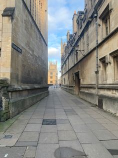 an empty city street lined with stone buildings