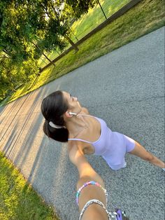 a woman is laying on the ground with headphones in her ears