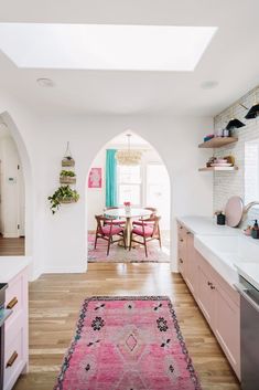 an archway leads to the dining room and kitchen in this modern, open concept home