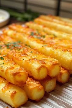 several pieces of fried food on a white plate with parsley sprinkled on top