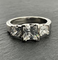 three stone diamond ring on top of a table