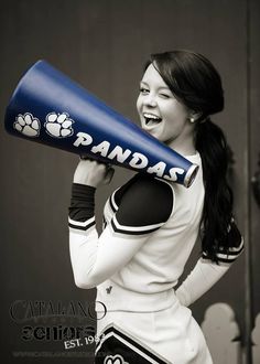 a woman is holding a baseball bat and laughing