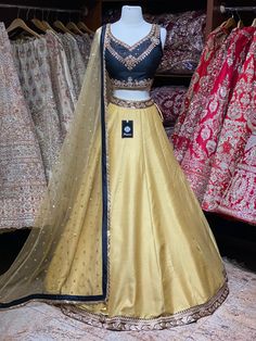 Bright gold plain skirt with black foiled work waist border paired with contrasting black kundan, stone and zardozi embroidery blouse and butti net dupatta. Fabric: Raw Silk This outfit can be customized in multiple colors and specific to client measurements. 90 days of production time is required and are for bulk orders only! Orders are processed in store only! Final fittings/alterations not included. Minimum Order Quantity- 4 pieces Gold Dola Silk Dress With Dori Work, Gold Chanderi Traditional Party Wear, Gold Traditional Wear With Zari Work For Party, Gold Traditional Party Wear With Zari Work, Gold Raw Silk Lehenga With Dori Work, Gold Zari Work Party Choli, Gold Lehenga With Zari Work For Party, Gold Raw Silk Traditional Party Wear, Traditional Gold Embellished Anarkali Set