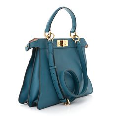 This is an authentic FENDI Calfskin Medium Peekaboo I SEE U Satchel in Blue Velvet and Light Rose. This stylish bag is crafted of soft calfskin leather in blue. The bag features a top handle and gold hardware including Fendi logo turn locks. When held by the top handle with the clasps open the interior details peek out. The top opens to a partitioned leather interior with a removable pouch. Fendi Logo, Oversized Bag, Versace Bags, Dior Jewelry, Light Rose, Pumps Flat, Wallet Fashion, Hobo Handbags, Stylish Bag