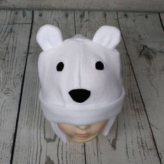 "Baby and Kids Polar Bear Fleece Hat This is a polar bear hat made from white fleece. It features felt eyes, felt nose, and fleece ears. Hat Sizes: Baby: Approx. 20\" around Child: Approx. 22\" around Youth: Approx. 23 1/2\" around Hat shown is a child size on a 18 1/2\" (47cm) head. Care: Machine wash on cool or warm; dry on low. Turnaround time is 1-3 business days. Standard Shipping is usps first class (3-5 business days). Upgrade to priority (2-3 day) and priority express (1-2 day) is availa Playful White Bonnet For Winter, Adjustable Warm White Bonnet, Playful White Adjustable Beanie, Playful White Winter Bonnet, Playful Warm White Beanie, Playful Warm White Hat, Playful White Cap Beanie, Playful White Beanie For Winter, Playful White Beanie Cap