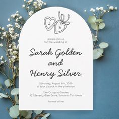 a wedding card with two hearts on it next to some baby's breath flowers